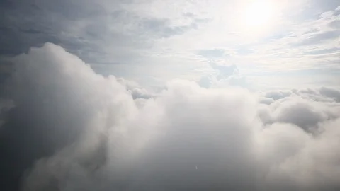 Thick, puffy clouds as seen from inside bloud ceiling with helicopter. 스톡 동영상 122453330