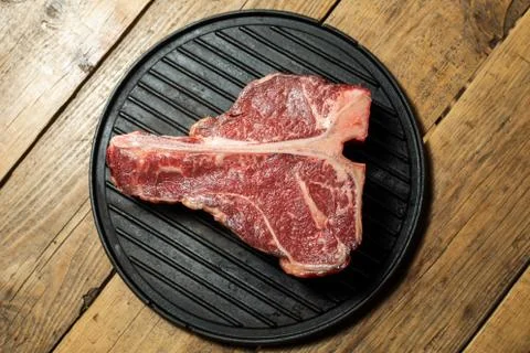 Thick Raw T-Bone Steak with Seasoning and Rosemary Stock Photos