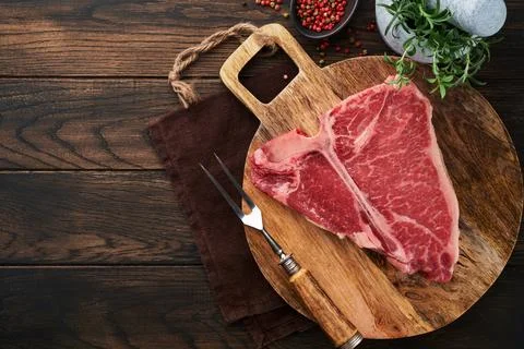 Thick Raw T-Bone Steak. Dry-aged Raw T-bone or porterhouse beef meat Steak on Stock Photos