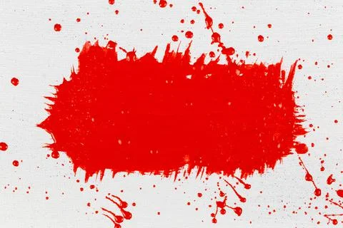 Thick red acrylic paint applied in an uneven patch on a flat surface Foto stock