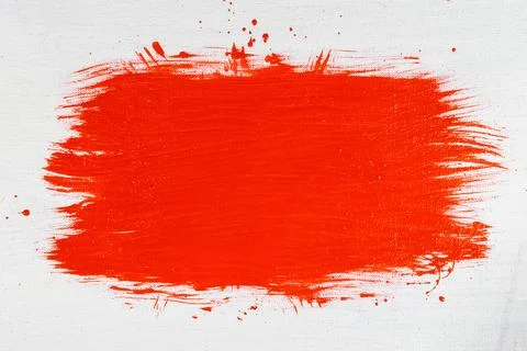 Thick red acrylic paint applied in an uneven patch on a flat surface Stock Photos