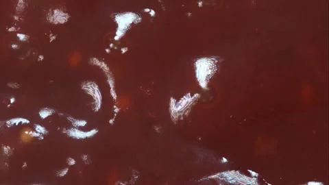 Thick red sauce bubbles while boiling hot Stock Footage 327180073