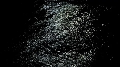 Thick ripples of light on black water Stock Footage 77862830