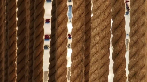 Thick ropes hanging vertically creating a textured pattern Stockbeeldmateriaal 312122198