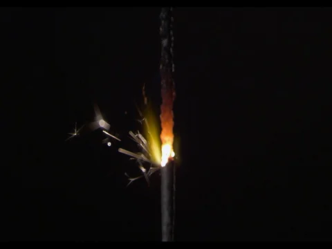 A thick short sparkler burning, Sparks are flying, close-up, camera moving along Stock Footage 74310148