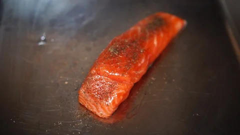 Thick slice of colorful raw fish meat orange salmon steak fillet covered in Stock Footage 106981721