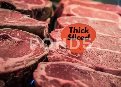 Thick sliced raw beef on display Stock Photos