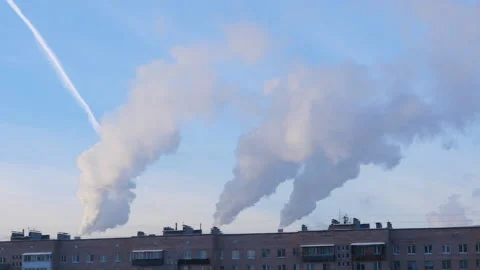 Thick smoke billows from the chimneys in the middle of the city Stock-Footage 168781279