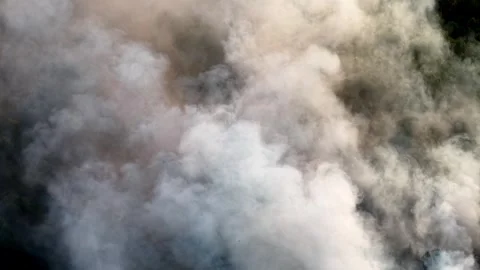 Thick smoke rises from a fire Stock-Footage 337984555