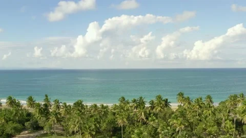 Thick snow-white clouds slowly float across the sky over the endless blue ocean. Stock Footage 167923575