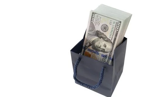 Thick stack of US one hundred dollar bills inside a small dark blue paper s.. Stock Photos