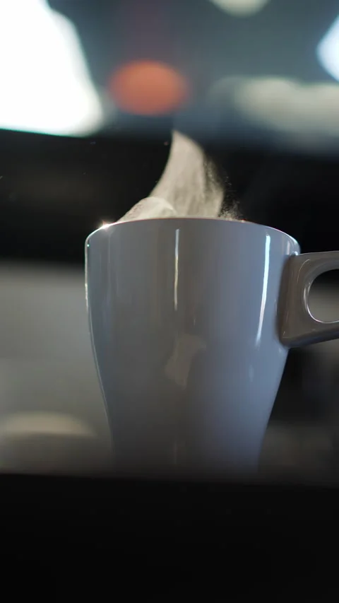 Thick steam cloud billowing from gray mug in slow motion Stock Footage 334499665