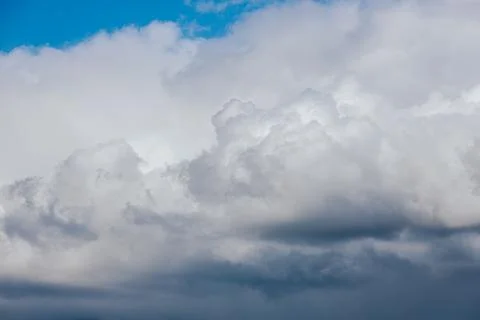 Thick storm clouds stretch across the sky with a visible curtain of rain falling Foto stock