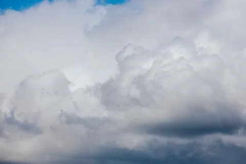 Thick storm clouds stretch across the sky with a visible curtain of rain falling Foto stock