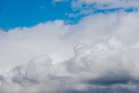Thick storm clouds stretch across the sky with a visible curtain of rain falling Foto stock