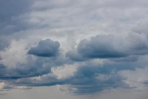 Thick storm clouds stretch across the sky with a visible curtain of rain falling Foto stock