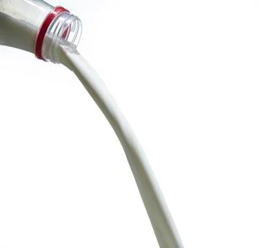 A thick stream of fresh milk flows from a plastic bottle Stock Photos