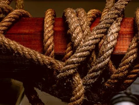 Thick Twisted Jute Rope Knots Tied to Wooden Beam Close Up Nautical Detail Stock Photos