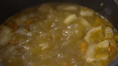 Thick vegetable stew in motion boiling with bubbles close up Stock Footage 333471845