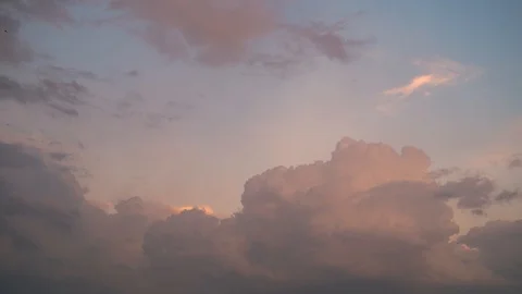 Thick white beautiful clouds, painted in the color of a pink summer sunset. Stock Footage