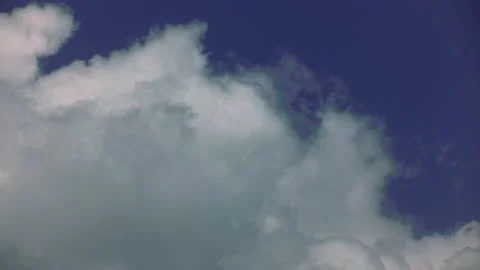 Thick white clouds against the blue sky. Time laps. Stock Footage 142079143