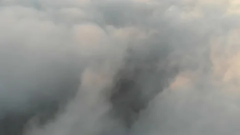 Thick white clouds flying sideways over the city, evening scene, cinematic view Stock Footage 157814320