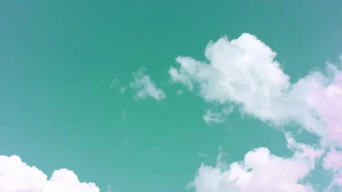 Thick white clouds swirl in the turquoise sky. Time laps. Stock Footage 142081733