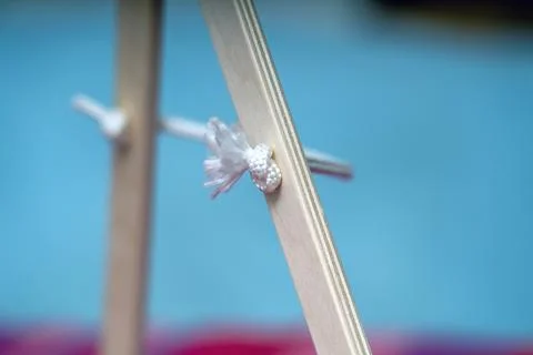 Thick white rope threaded through a hole in a wooden board, tied in a knot fo Stock Photos