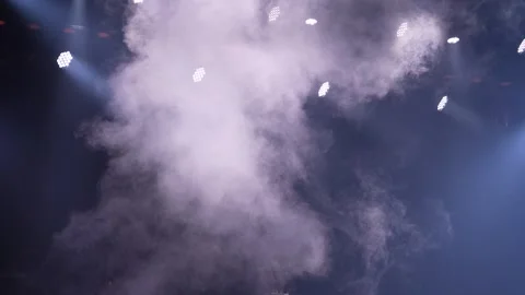 Thick white smoke billowing on dark stage with white LED lights Stockbeeldmateriaal 346357595