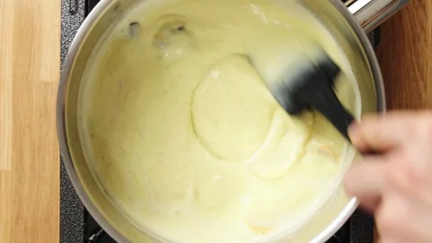 Thickening mixture is stirred with silicone spatula in saucepan. Stock Footage 345273997