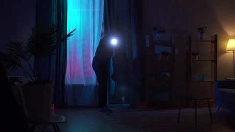 Thief in a balaclava climbs through the window of an apartment Stock Footage 155105955