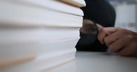 Thief in balaclava looking documents with magnifying glass 4k movie slow motion Stock Footage 273785664