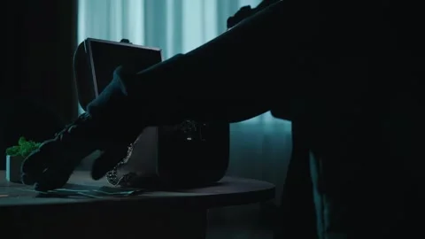 A thief commits a robbery in a dark apartment, using a flashlight. Hands of a Stock Footage 249525360