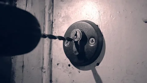 The thief drilling the lock in the door. Stock Footage 201220050