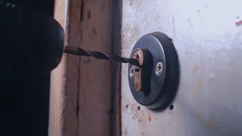 The thief drilling the lock in the door. Stock Footage 201220053