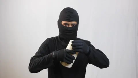 Thief glanced in all directions and opened the plastic jar Stock Footage 319411698