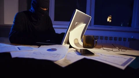The thief hacker working on laptop in the night stealing data Stock Footage 69882153