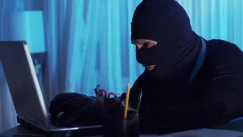 The thief hacker working on laptop in the night stealing data Stock Footage 70532156