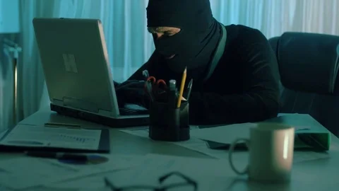 The thief hacker working on laptop in the night stealing data Stock Footage 70532231