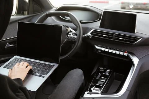 Thief hacking car system with laptop inside vehicle, closeup Stock Photos