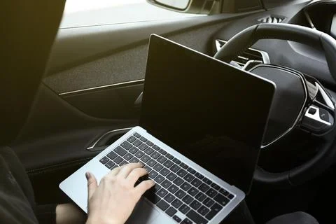 Thief hacking car system with laptop inside vehicle, closeup Stock Photos
