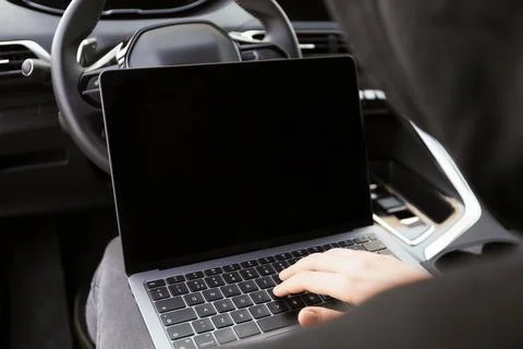 Thief hacking car system with laptop inside vehicle, closeup Stock Photos
