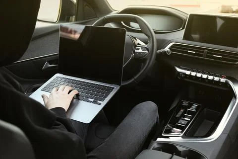 Thief hacking car system with laptop inside vehicle, closeup Stock Photos