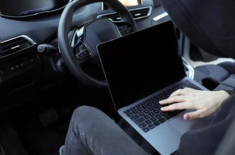 Thief hacking car system with laptop inside vehicle, closeup Stock Photos