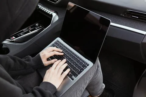 Thief hacking car system with laptop inside vehicle, closeup Stock Photos