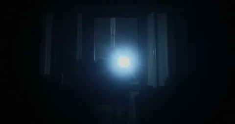 Thief is Looking inside the House Through the Windows with Flashlight Opening Stock Footage 119287528