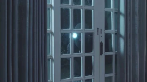 Thief Man Holding Flashlight Looking Inside The House While Standing Outside Stock Footage 197378073