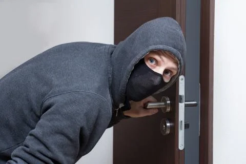 Thief opening door Stock Photos