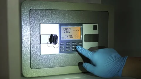 The thief is opening a safe and take out the money from the safe Stock Footage 277934959