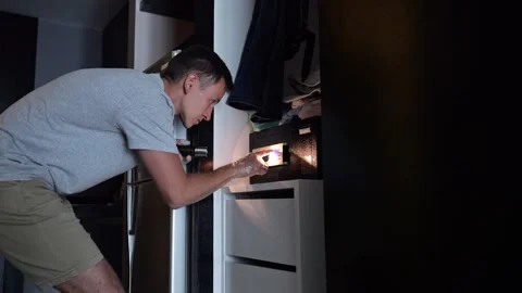 Thief opens hotel safe box lighting up face with excitement Stock Footage 302153469